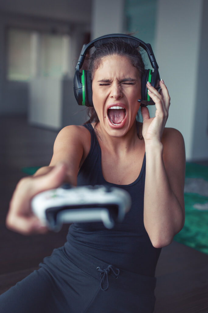 Gamer woman shouting into microphone while playing online