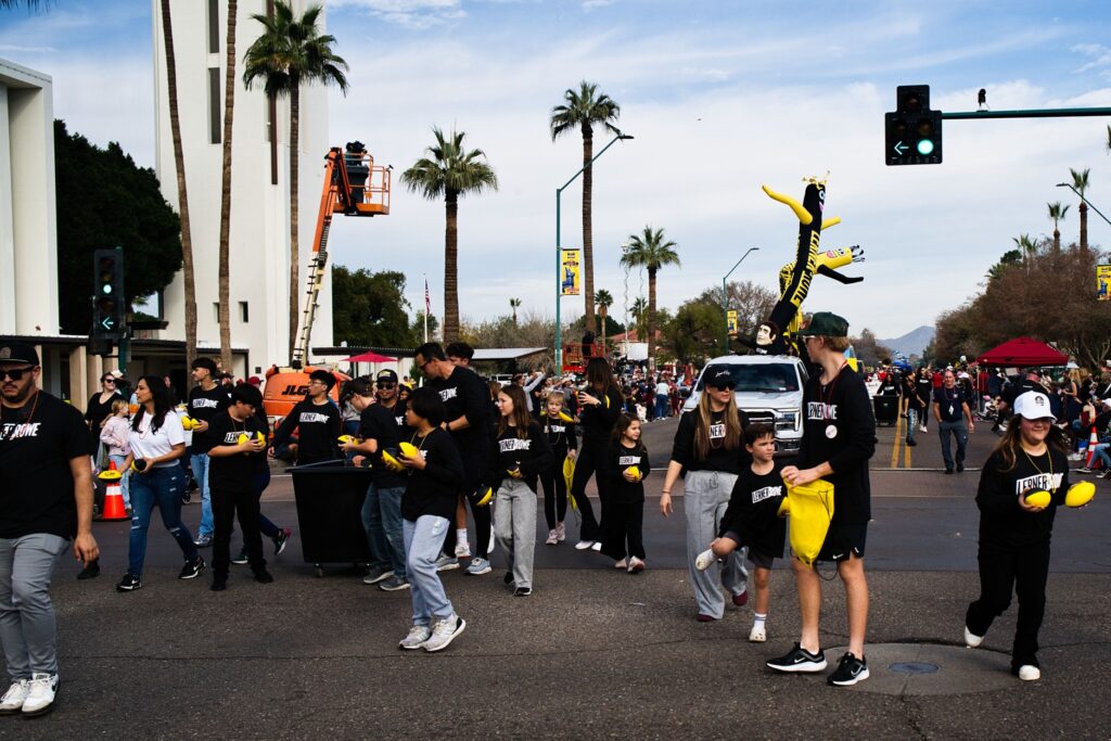 Lerner and Rowe team members with footballs in downtown Phoenix